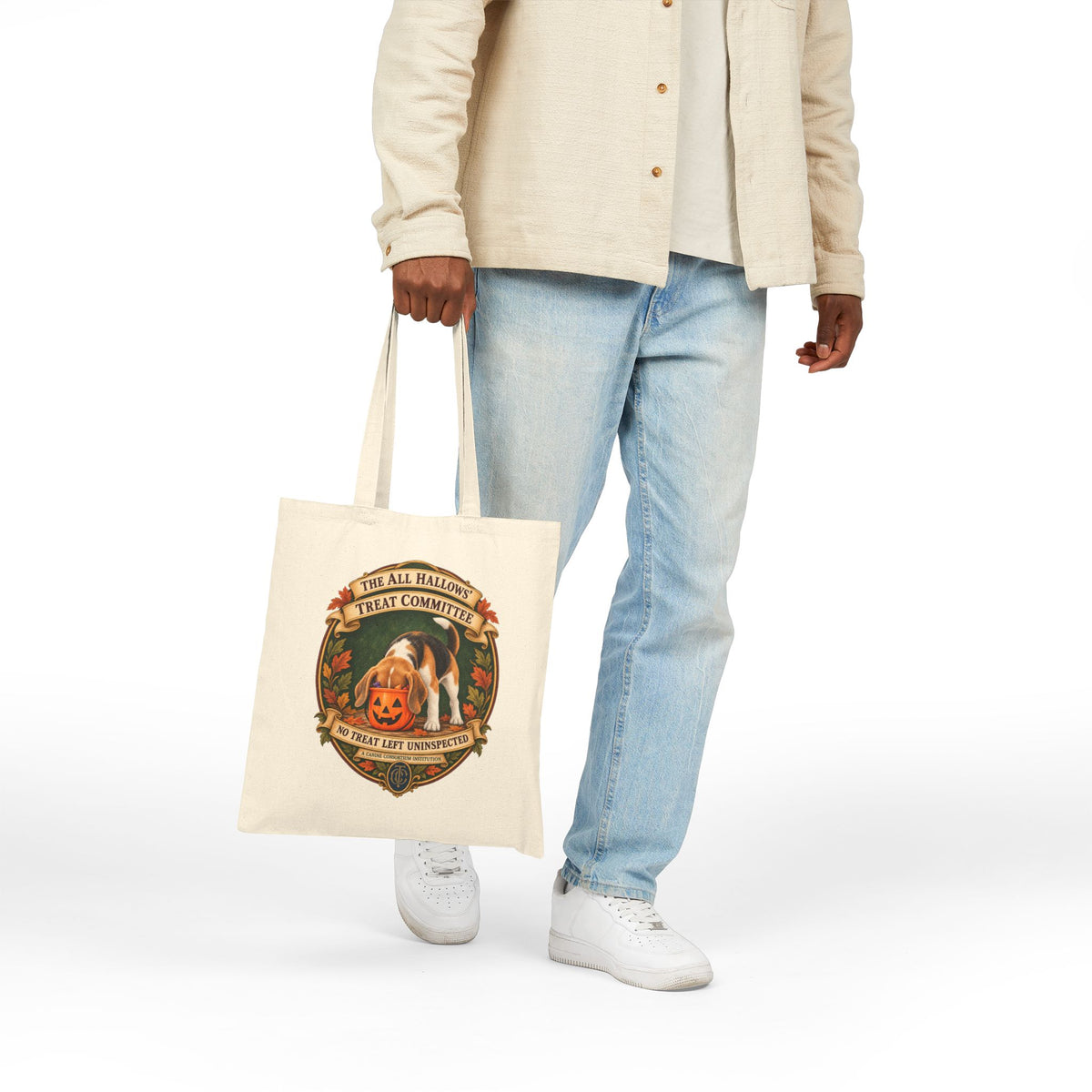Person holding natural canvas Beagle Halloween tote by the handles, full-length lifestyle view